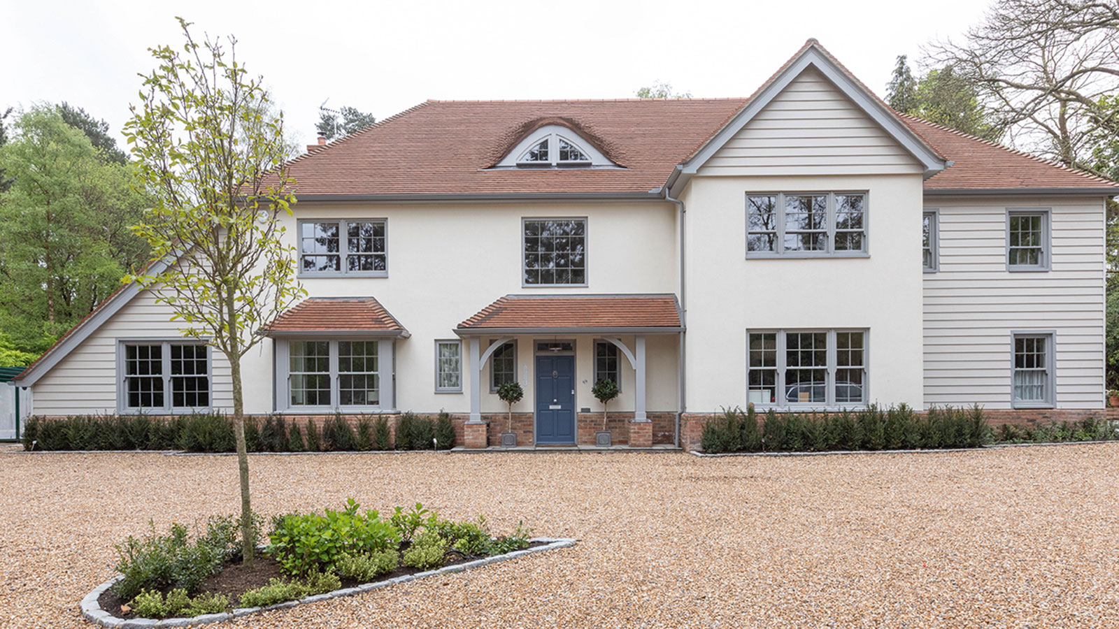 White rendered UK house with a clean ridge line